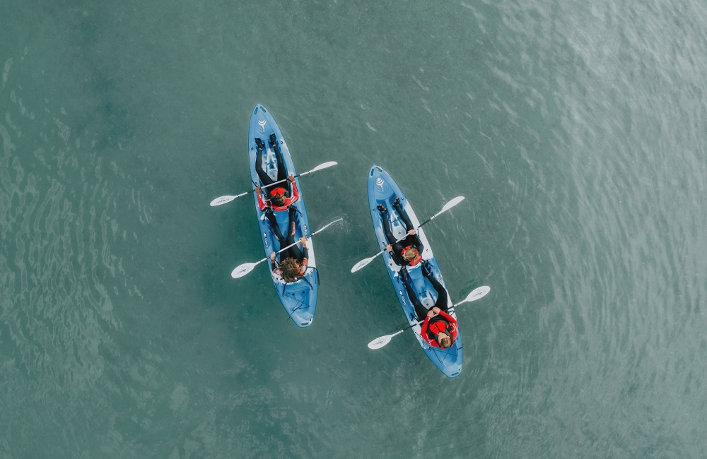 Group of friends on kayaks in the ocean 