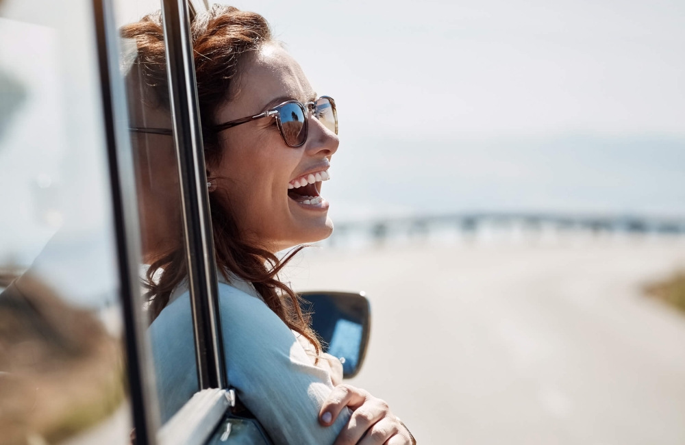 Woman leaning out a car window 