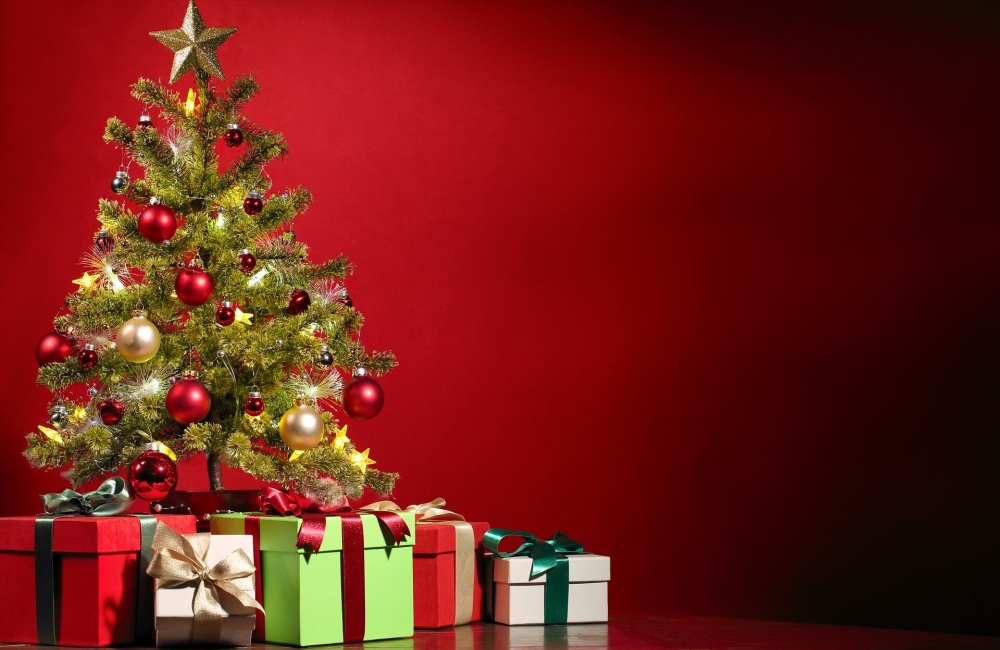 christmas tree with gifts wrapped in ribbon