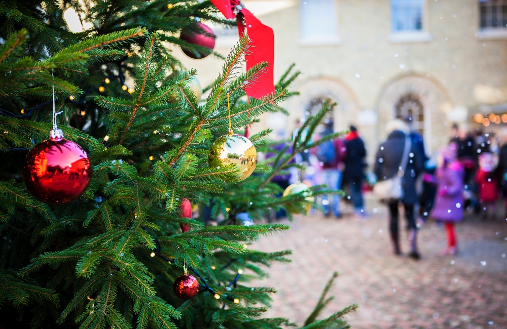 a christmas tree with red baubles and ribbons