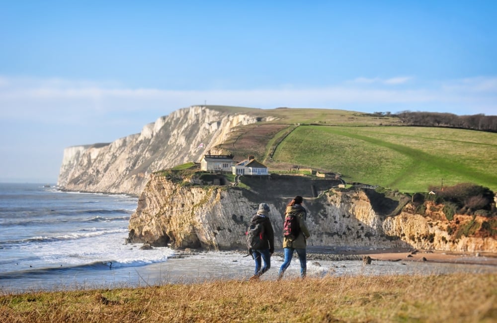 two people walking across Freshwater bay