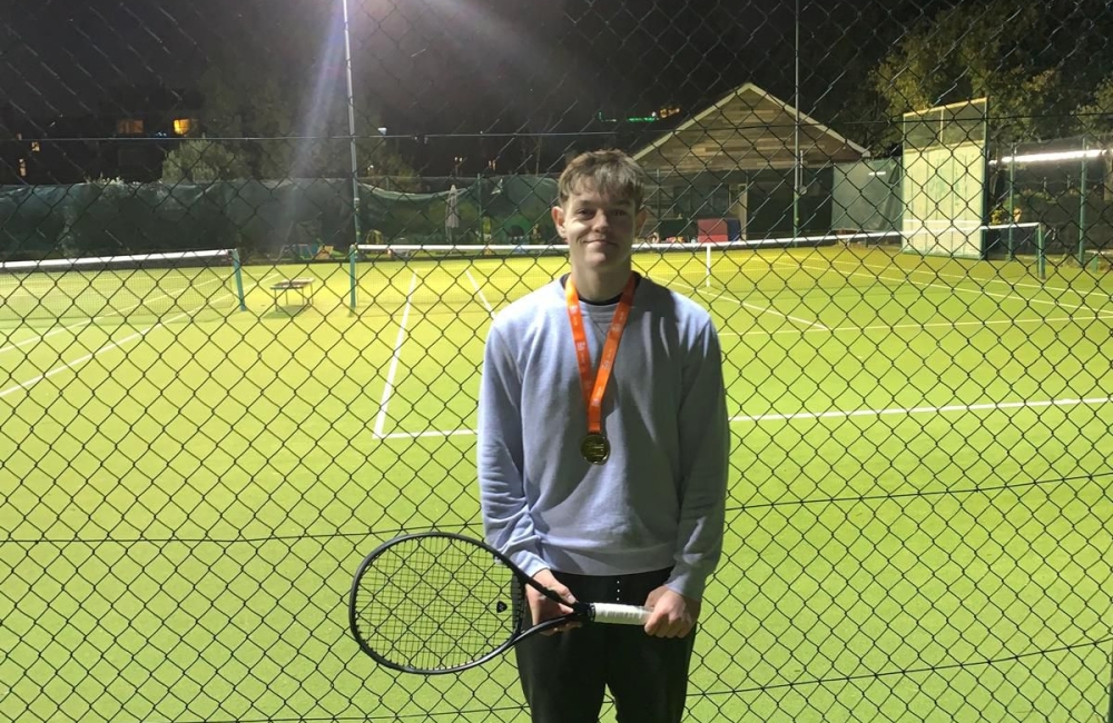 Toby Trotman in front of the tennis courts