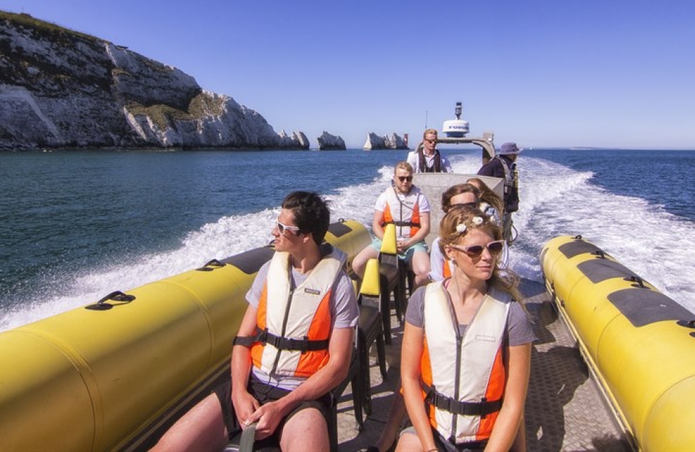 Visitors on a boat tour of Alum Bay