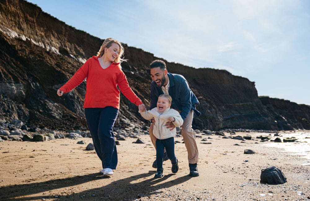 family playing on the beach