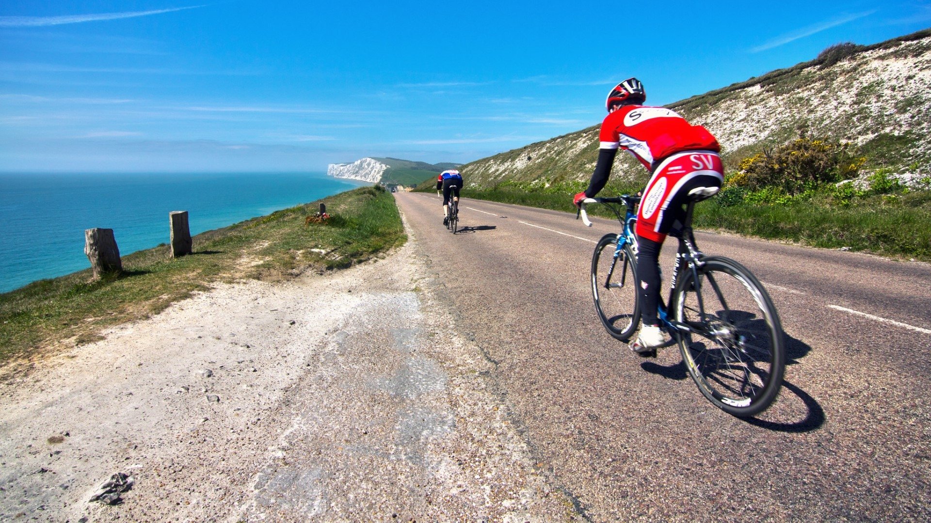 cyclists with the sea in the background