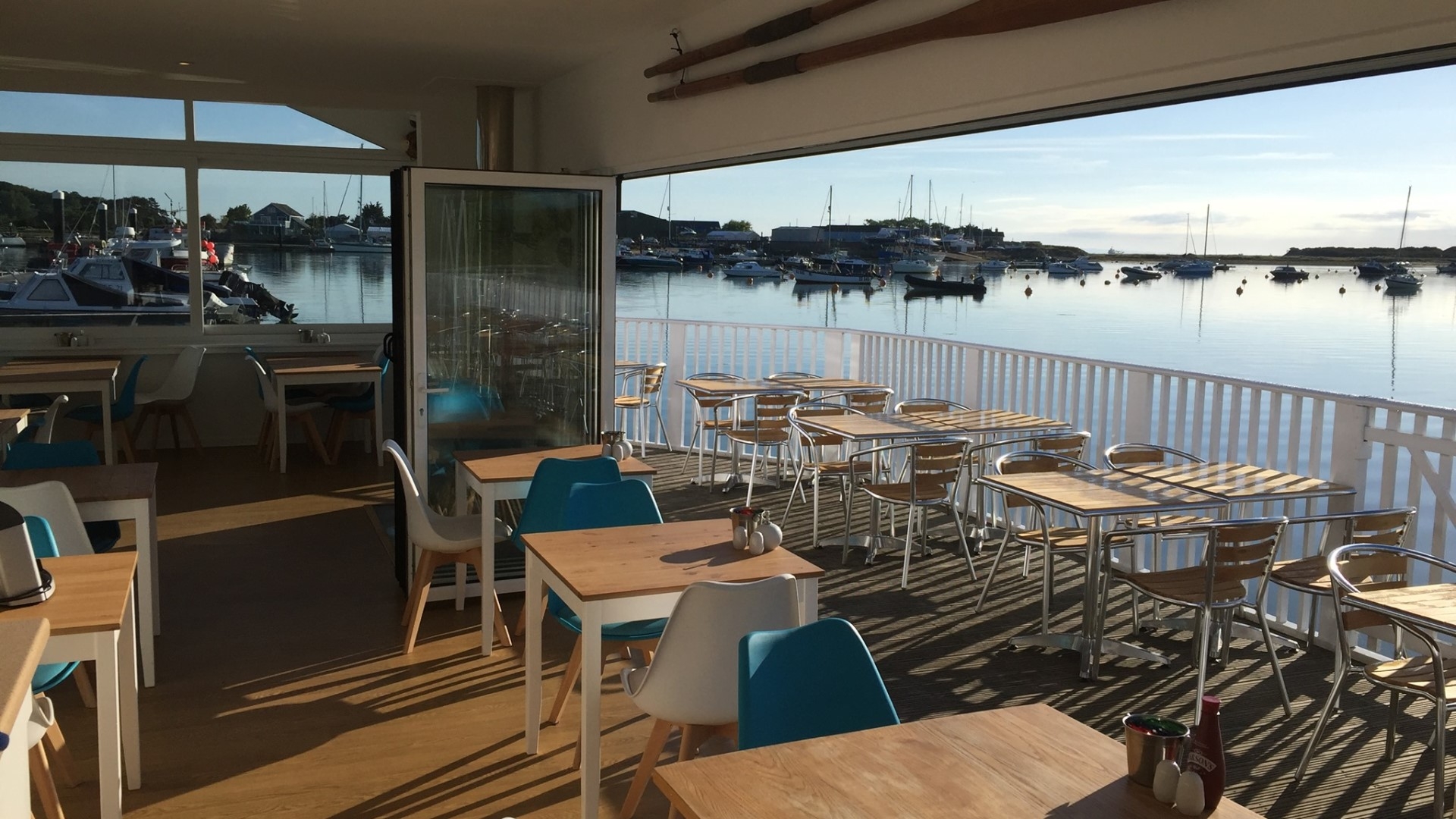 restaurant interior with tables overlooking bembridge harbour