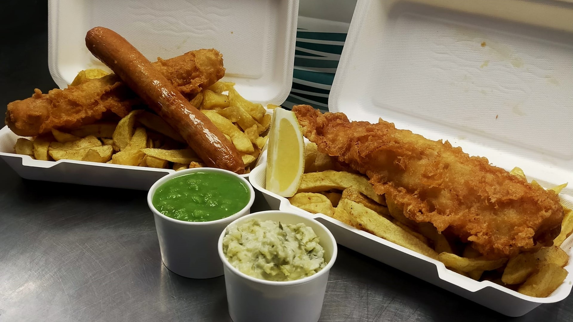 sausage, battered sausage, and battered fish with chips and mushy peas