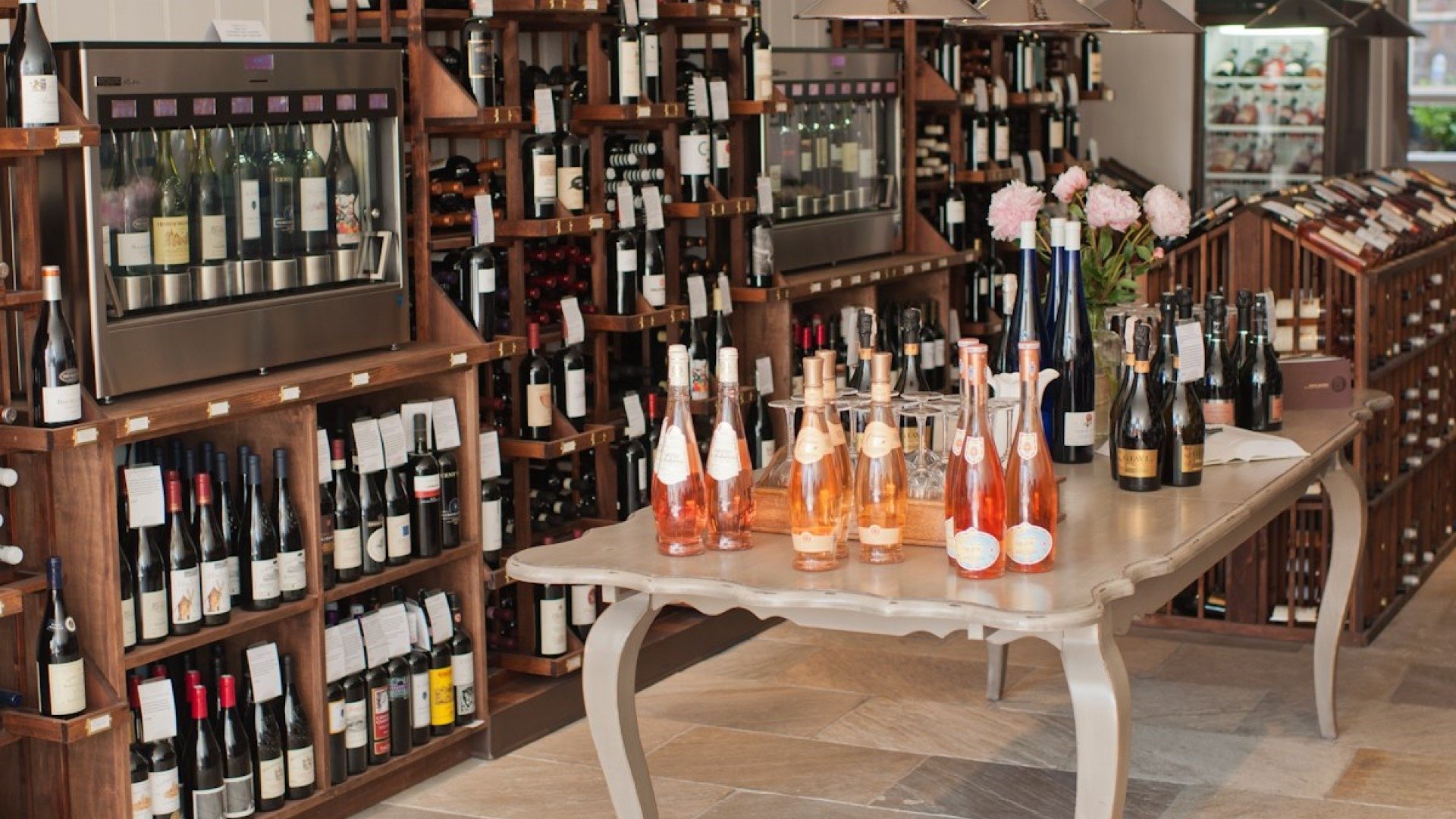 Inside Wine Therapy, bottles of wine on a table surrounded by shelves of wine bottles