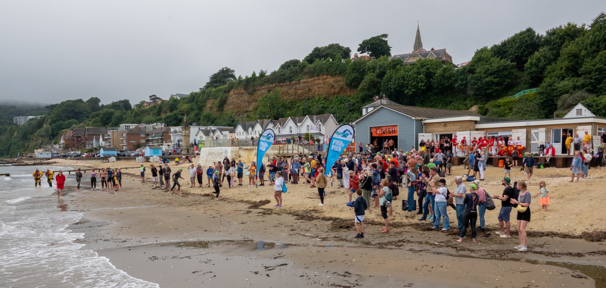 people on the beach about to swim