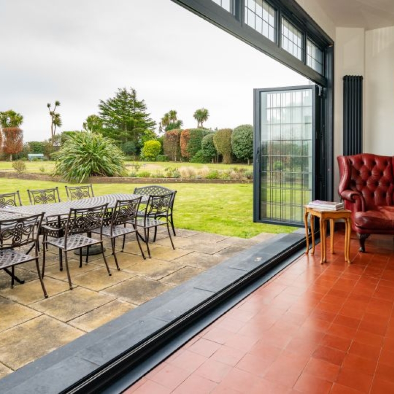 Art Deco HouseUK bi-folding doors leading from the garden room on to the patio