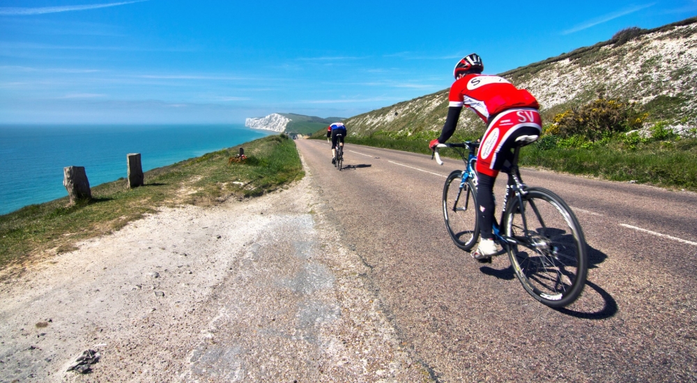 cyclists with the sea in the background