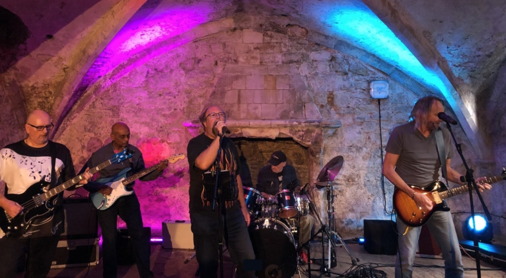 band playing in medieval vault