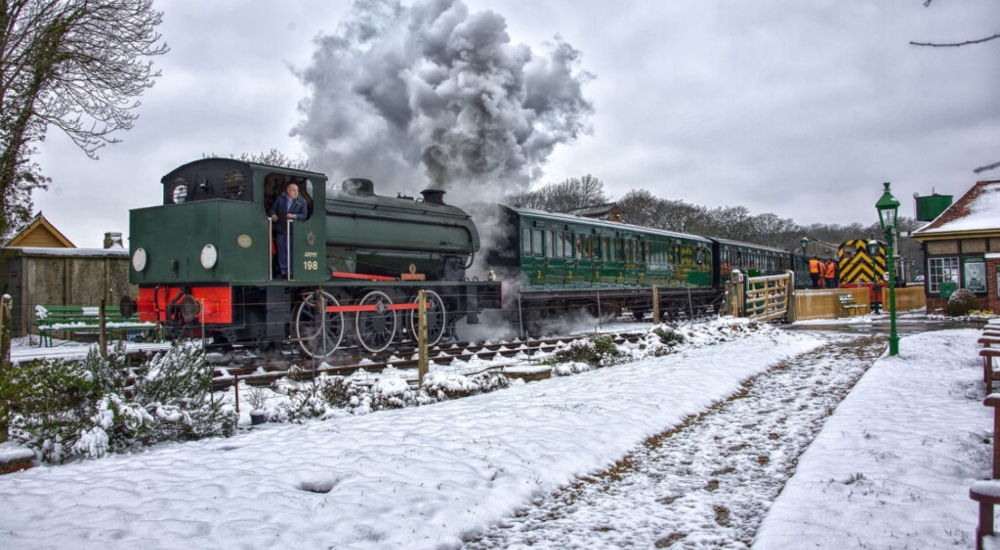 a steam train in the snow