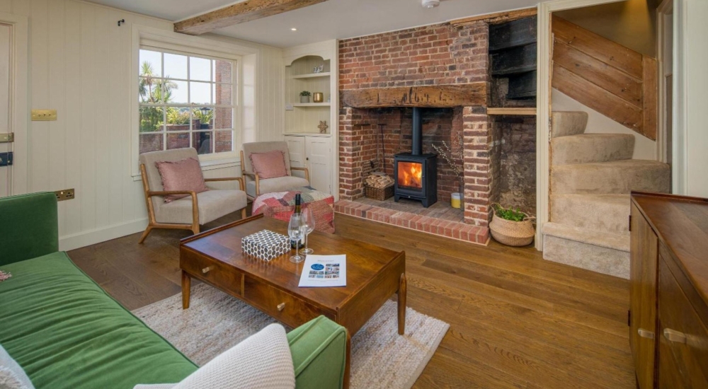 interior of cottage living room with lit log burner