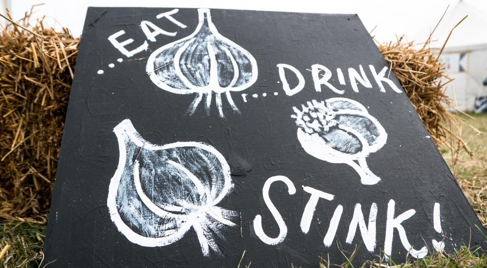 blackboard sign saying 'eat drink and stink'