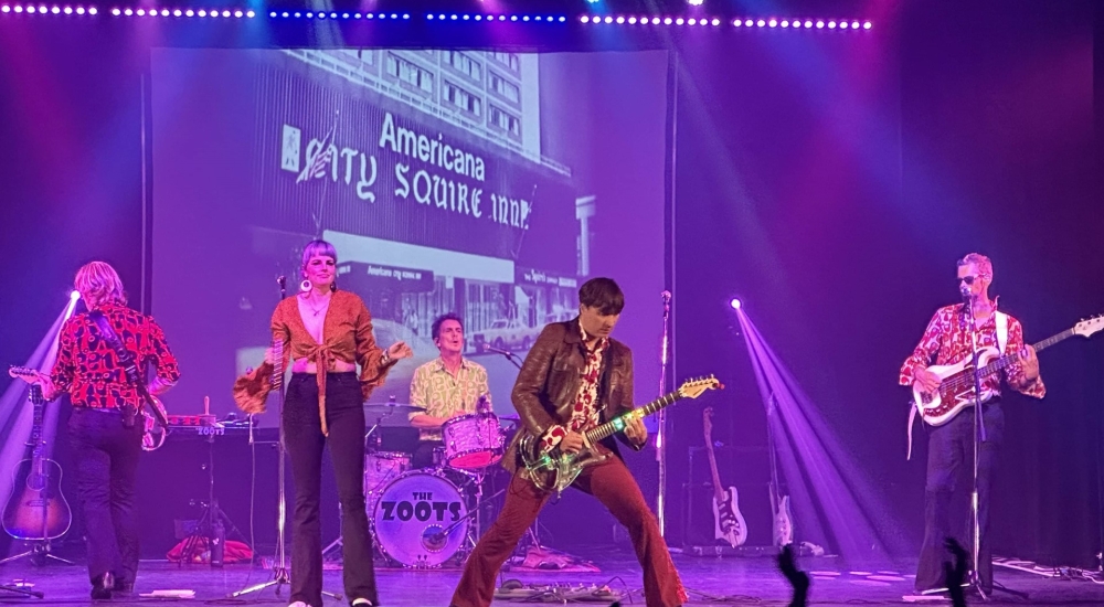 the zoots on stage with guitars and strobe lights