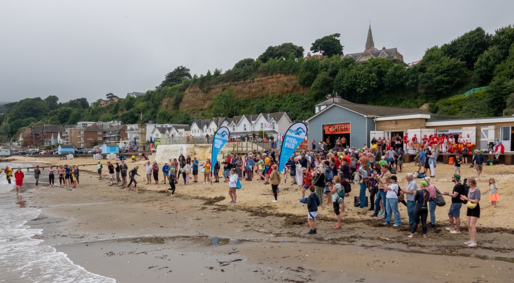 people on the beach about to swim