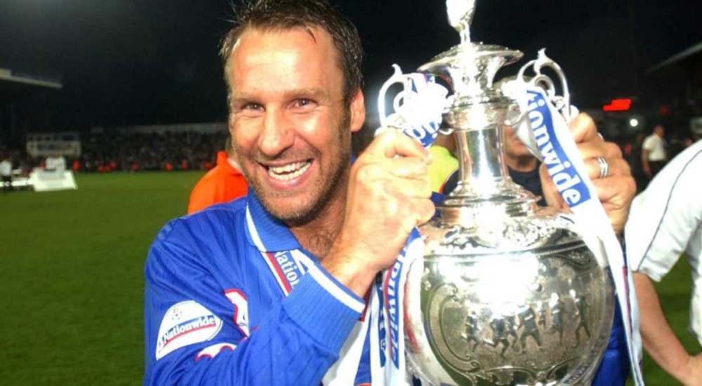 paul merson in portsmouth kit holding trophy