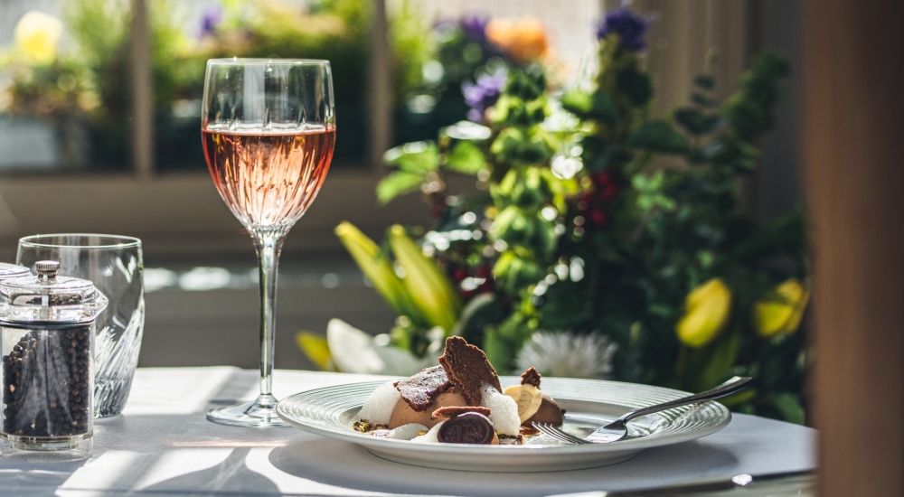 plate of food and glass of rose wine 