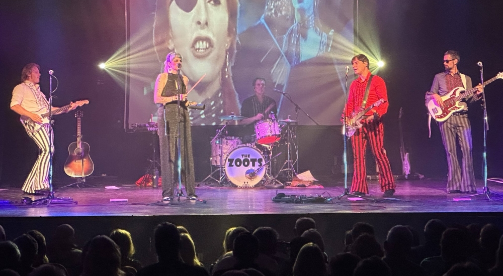 the zoots on stage with guitars and strobe lights