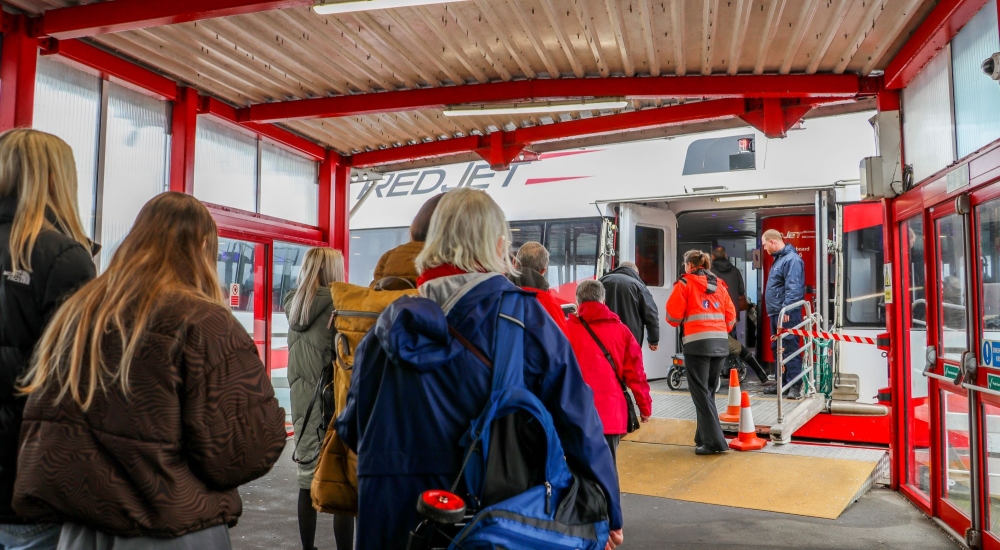 people boarding red jet in west cowes